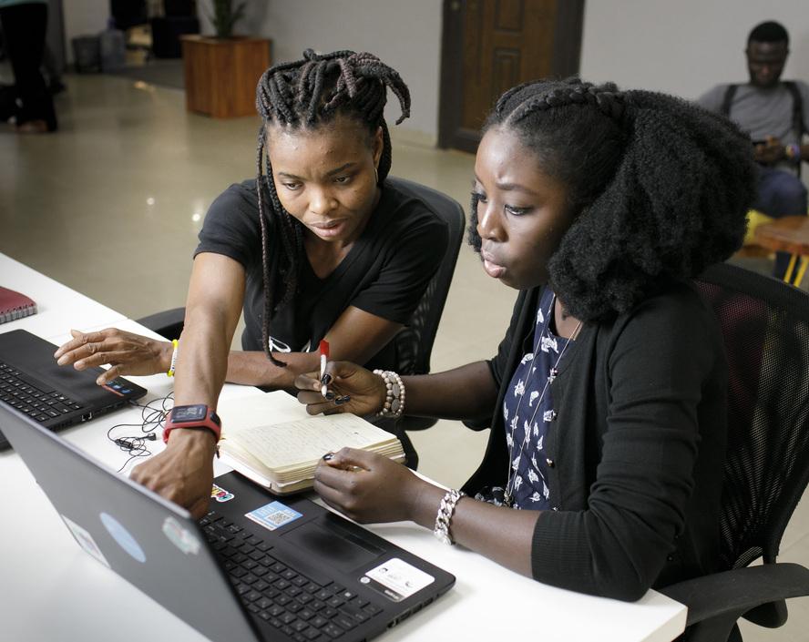 2 ladies looking at a laptop screen